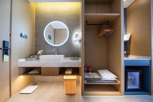 a bathroom with a sink and a mirror at Atour Hotel Nanjing Qidi Street Qinlin Science and Technology Park in Jiangning