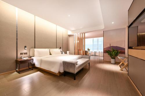 a bedroom with a large bed and a large window at Atour Hotel Beijing Yizhuang New Town Majuqiao in Daxing