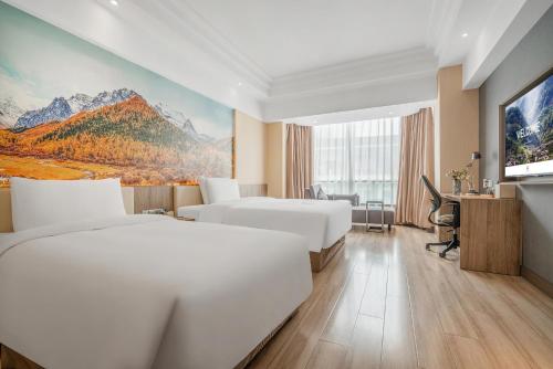 a hotel room with two beds and a tv at Atour Hotel Chengdu Taikoo Li Riverside in Chengdu