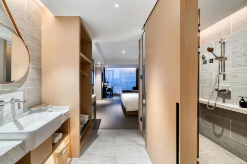 a bathroom with a sink and a shower at Atour Hotel Hangzhou Binjiang Powerlong City in Hangzhou