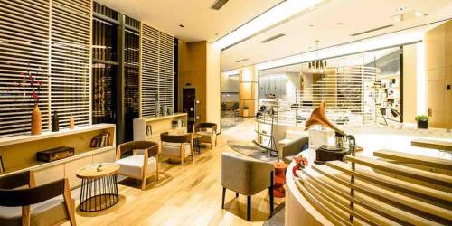 a living room with a lot of chairs and tables at Atour Hotel Qinhuangdao Xiangxi Sea in Qinhuangdao