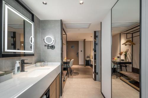 ein Badezimmer mit 2 Waschbecken und einem Spiegel in der Unterkunft Atour Hotel Nanchang Bayi Square Provincial Television Station in Nanchang