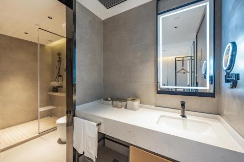 a bathroom with a sink and a mirror at Atour Hotel Shanghai Huajing in Shanghai