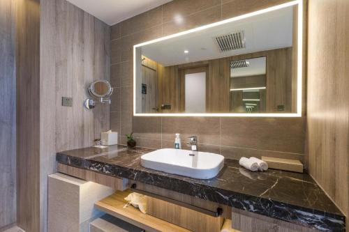 a bathroom with a sink and a mirror at Atour Hotel Xining East Kunlun Road in Xining