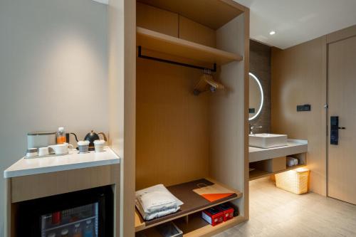 a bathroom with a fireplace and a sink at Atour Hotel Taizhou Linhai Taizhou University in Linhai