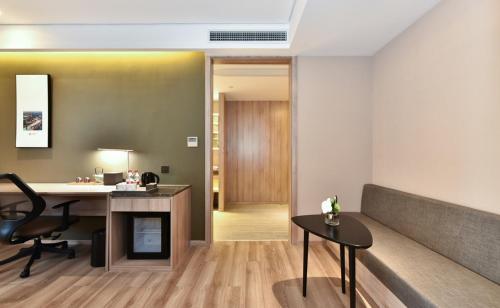 an office with a desk and a table and a chair at Atour Hotel Tianjin Binhai 1st Street in Binhai
