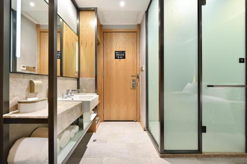 a bathroom with a sink and a shower at Atour X Hotel Beijing Sanlitun Agricultural Exhibition Hall in Beijing