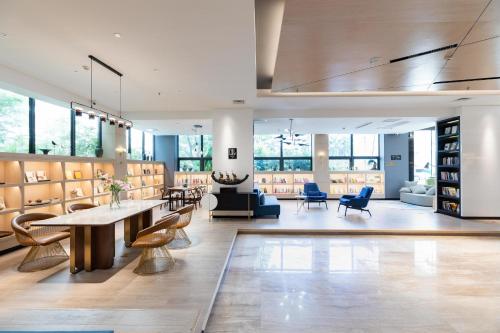 a large room with tables and chairs in a library at Atour Hotel Xiamen Xiagu Cruise Center in Xiamen