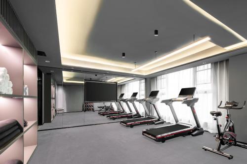 a room with a bunch of exercise bikes and a screen at Atour Hotel Quanzhou Jinjiang Sunshine Plaza in Jinjiang