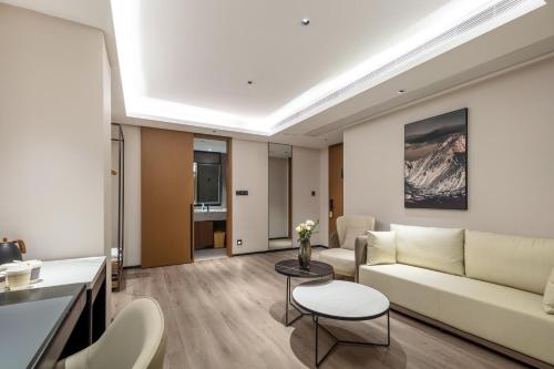 a living room with a couch and a table at Atour Hotel Quanzhou Jinjiang Sunshine Plaza in Jinjiang