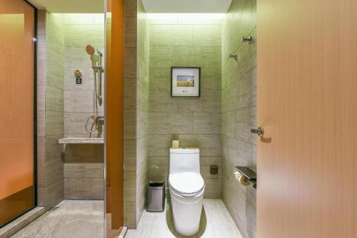 a bathroom with a white toilet and a sink at Atour Hotel Beijing Wangjing 798 Art District in Beijing