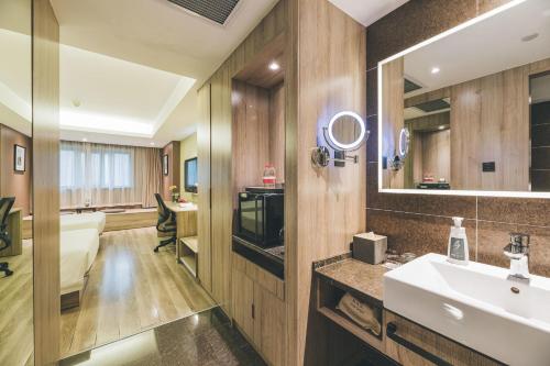 a bathroom with a sink and a mirror at Atour Music Hotel Hangzhou West Lake in Hangzhou