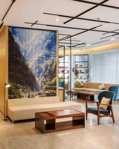 a living room with a couch and a table at Atour Hotel Shenzhen Nanshan Coast City in Shenzhen