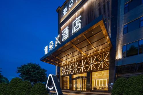 a rendering of the front of a building at night at Atour X Hotel Guangzhou Baiyun International Airport Renhe Station in Guangzhou
