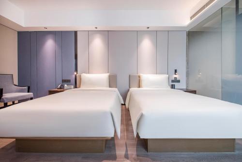two beds in a hotel room with two beds at Atour X Hotel Dongguan Chang'an Wanda in Dongguan