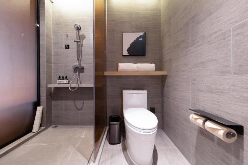 a bathroom with a white toilet and a shower at Atour Hotel Zhuhai Tangjiawan University Jinding Plaza in Zhuhai
