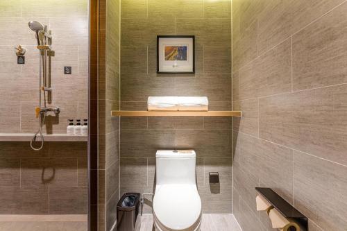 a bathroom with a toilet and a shower at Atour Hotel Beijing Dahongmen Yintai in Beijing