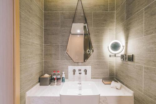 a bathroom with a sink and a mirror at Atour Hotel Shanghai Hongqiao International Exhibition Linkong Park in Shanghai
