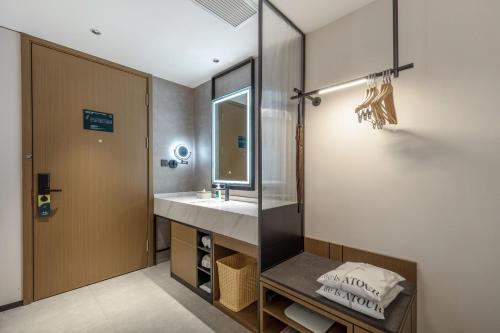 a bathroom with a sink and a mirror at Atour Hotel Quanzhou Jinjiang Sunshine Plaza in Jinjiang