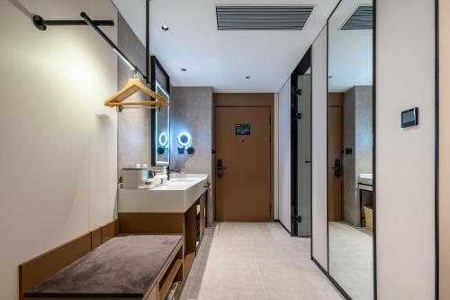 a bathroom with a sink and a mirror at Atour Hotel Zhoushan Putuo Banshengdong Wharf in Zhoushan
