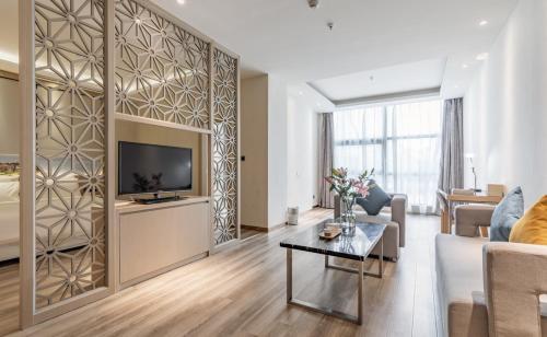 a living room with a large wall with a television at Atour Hotel Xiamen Xiagu Cruise Center in Xiamen