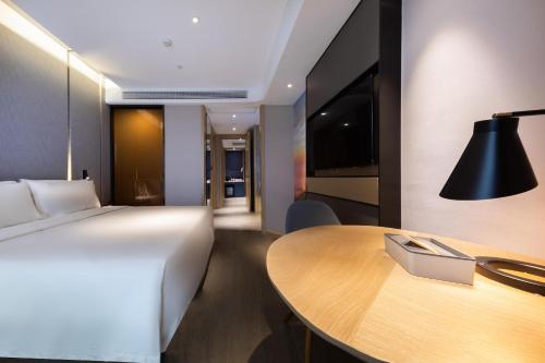 Ένα ή περισσότερα κρεβάτια σε δωμάτιο στο Atour Hotel Yichun Administrative Center