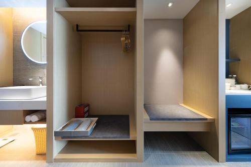 a walk in shower in a bathroom with a sink at Atour Hotel Shanghai Xinzhuang CBD in Shanghai