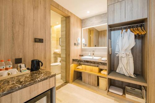 a bathroom with a sink and a toilet and a sink at Atour Hotel Xuzhou East Jianguo Road Suning Plaza in Xuzhou