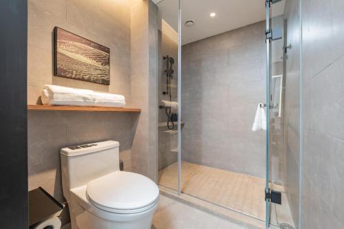 a bathroom with a toilet and a glass shower at Atour Hotel Guangzhou Pazhou Exhibition Center Information Port-Free shuttle bus to Canton Fair in Guangzhou