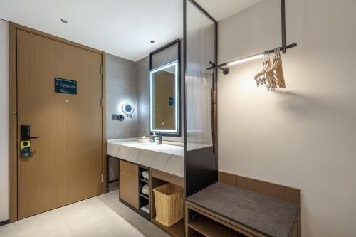a bathroom with a sink and a mirror at Atour Hotel Quanzhou Jinjiang Sunshine Plaza in Jinjiang