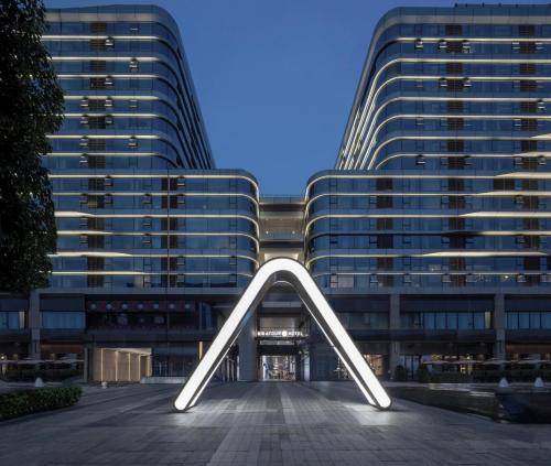 a large building with a large arch in front of it at Atour S Hotel Shanghai Hongqiao Center Aegean-Late night Congee in Shanghai