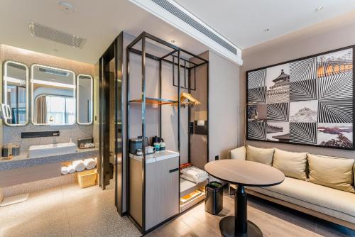a living room with a table and a couch at Atour S Hotel Beijing Shangdi Qinghe High Speed Railway Station in Beijing