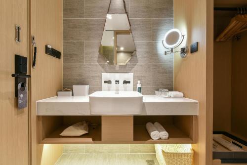 a bathroom with a sink and a mirror at Atour Hotel Beijing Wangjing Science and Technology Park in Beijing