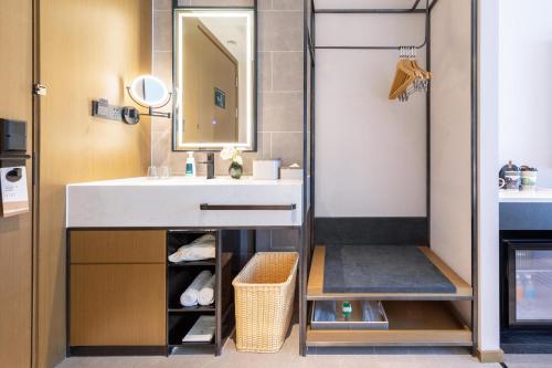 a bathroom with a sink and a mirror at Atour Hotel Beijing Capital Airport New International Exhibition Center in Beijing