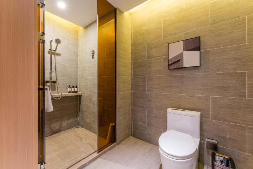 a bathroom with a toilet and a shower at Atour Hotel Chongqing Tiandi NetEase Cloud Music in Chongqing