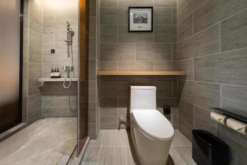 a bathroom with a toilet and a shower at Atour Hotel Shenzhen Fuhai International Convention and Exhibition Center in Bao'an