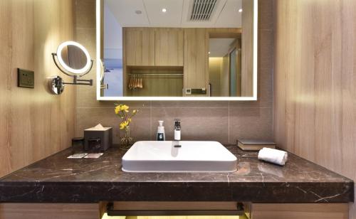 a bathroom with a sink and a mirror at Atour Hotel Beijing Yizhuang Mobile Silicon Valley in Daxing