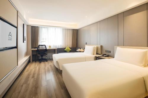 Ένα ή περισσότερα κρεβάτια σε δωμάτιο στο Atour Hotel Chongqing Shapingba High Speed Railway Station Sanxia Plaza