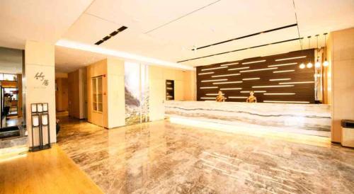 a large empty room with a large garage door at Atour Hotel Yantai South Station Yingchun Street in Yantai
