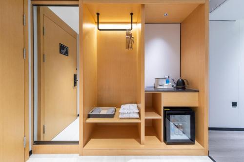 a room with a door open to a kitchen at Atour X Hotel Guangzhou Baiyun International Airport Renhe Station in Guangzhou