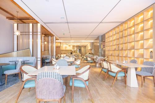 a restaurant with tables and chairs in a room at Atour Hotel Chongqing Guanyinqiao Flower Garden in Chongqing