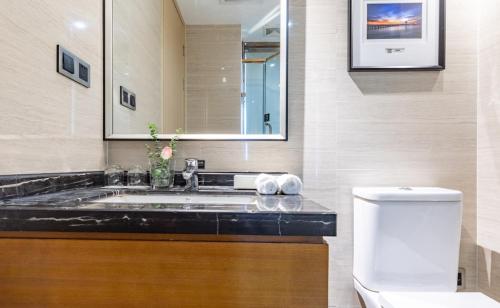 a bathroom with a sink and a toilet at Atour Hotel Xiamen Xiagu Cruise Center in Xiamen