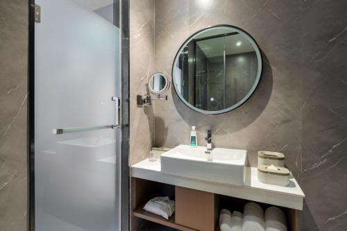a bathroom with a sink and a mirror at Atour X Hotel Zhuhai Gongbei Port High Speed Railway Station in Zhuhai