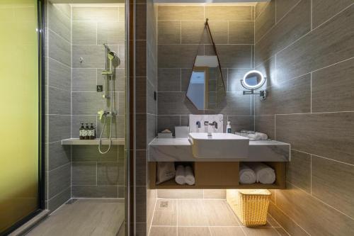 a bathroom with a sink and a shower at Atour Hotel Guiyang Guanshan Lake Park in Guiyang