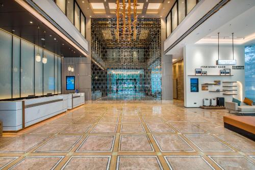a lobby of a building with a chandelier at Atour X Hotel Dongguan Chang'an Wanda in Dongguan