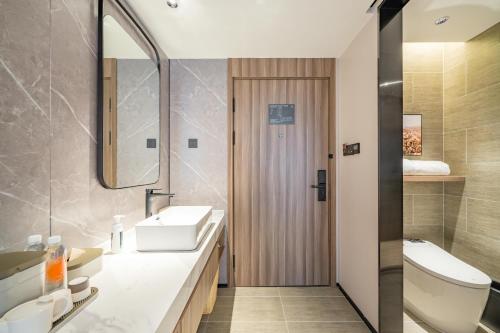 a bathroom with a sink and a toilet at Atour X Hotel Shanghai Central Bailian Tongchuan Road Station in Shanghai