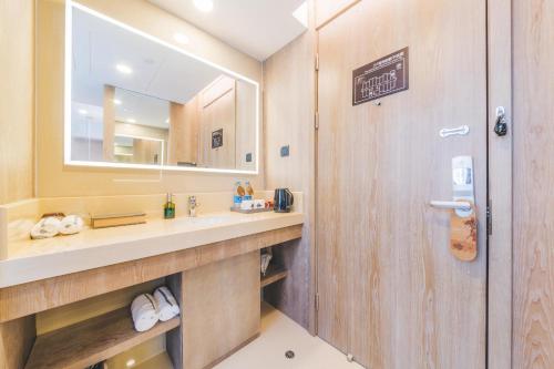 a bathroom with a sink and a mirror at Atour Hotel Shanghai Pudong Zhangjiang Park in Shanghai