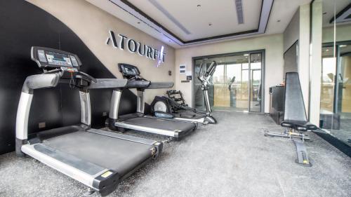 a gym with three treadmills and a treadmill at Atour Hotel Kunming Cuihu in Kunming