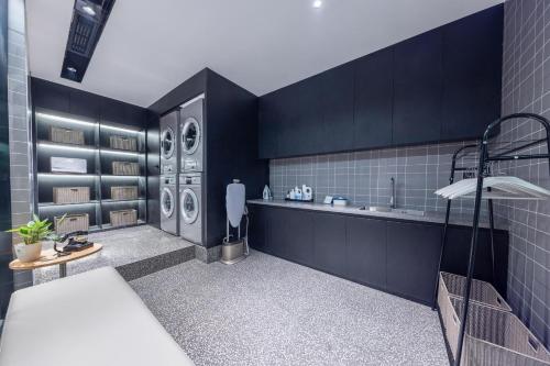 a bathroom with a sink and a washing machine at Atour Light Hotel Fuzhou Sanfang Qixiang in Fuzhou