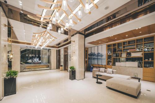 a living room with a couch and a table at Atour Hotel Chaozhou Ancient Town People's Square in Chaozhou